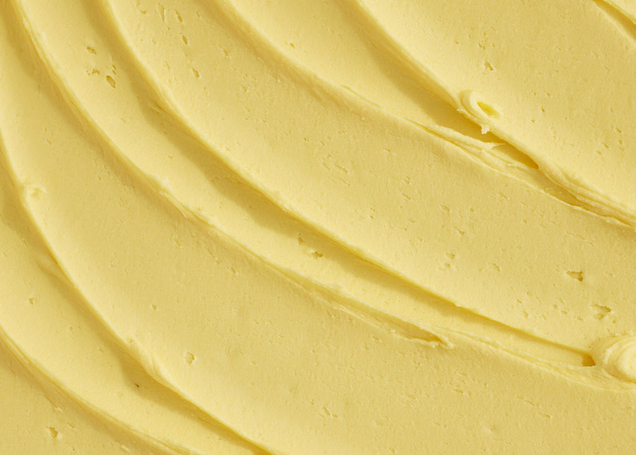Close-up of smooth yellow cream with concentric circles